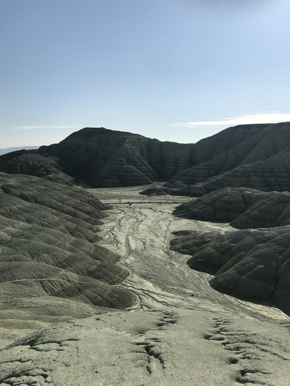 a rocky landscape with mountains in the background