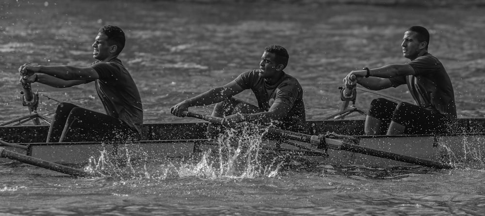 a group of men rowing a boat