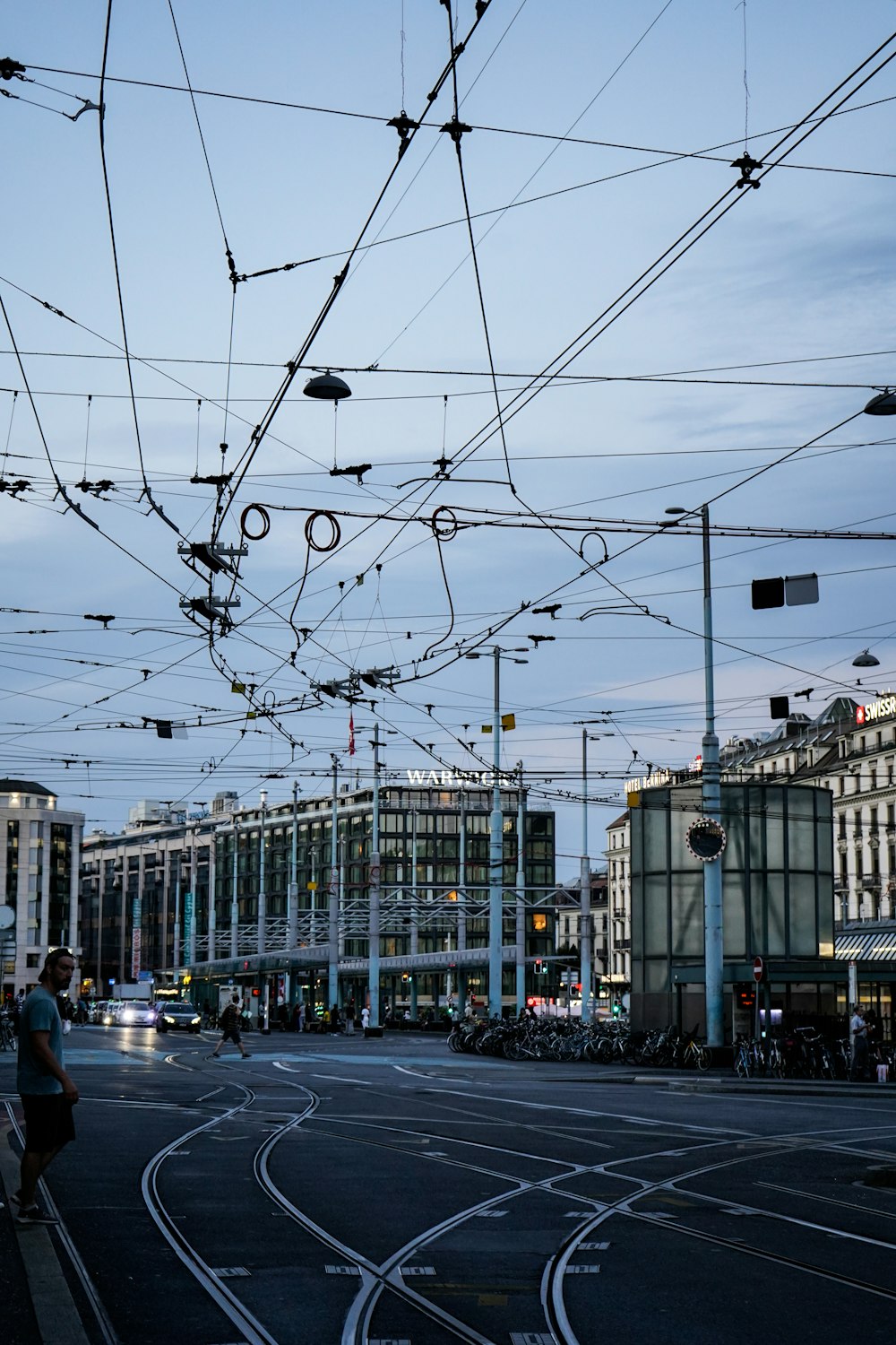 a street with buildings and wires above it