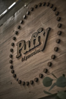 A minimalist stall setup with wooden accents and a small chalkboard menu featuring Dutch baby pancakes