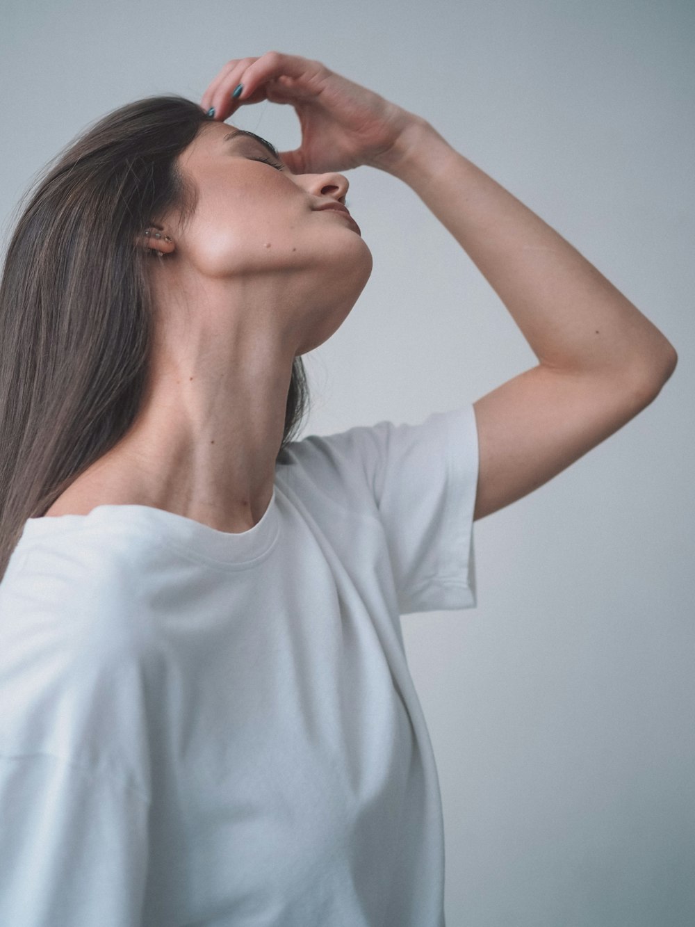 a woman with her hand on her face