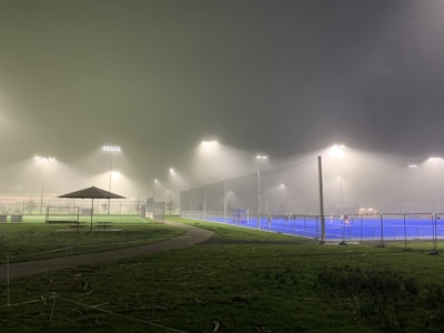Evening shot of a sports complex illuminated with nets ensuring player safety in Mumbai