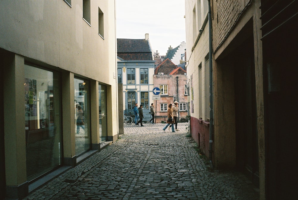 people walking on a brick street