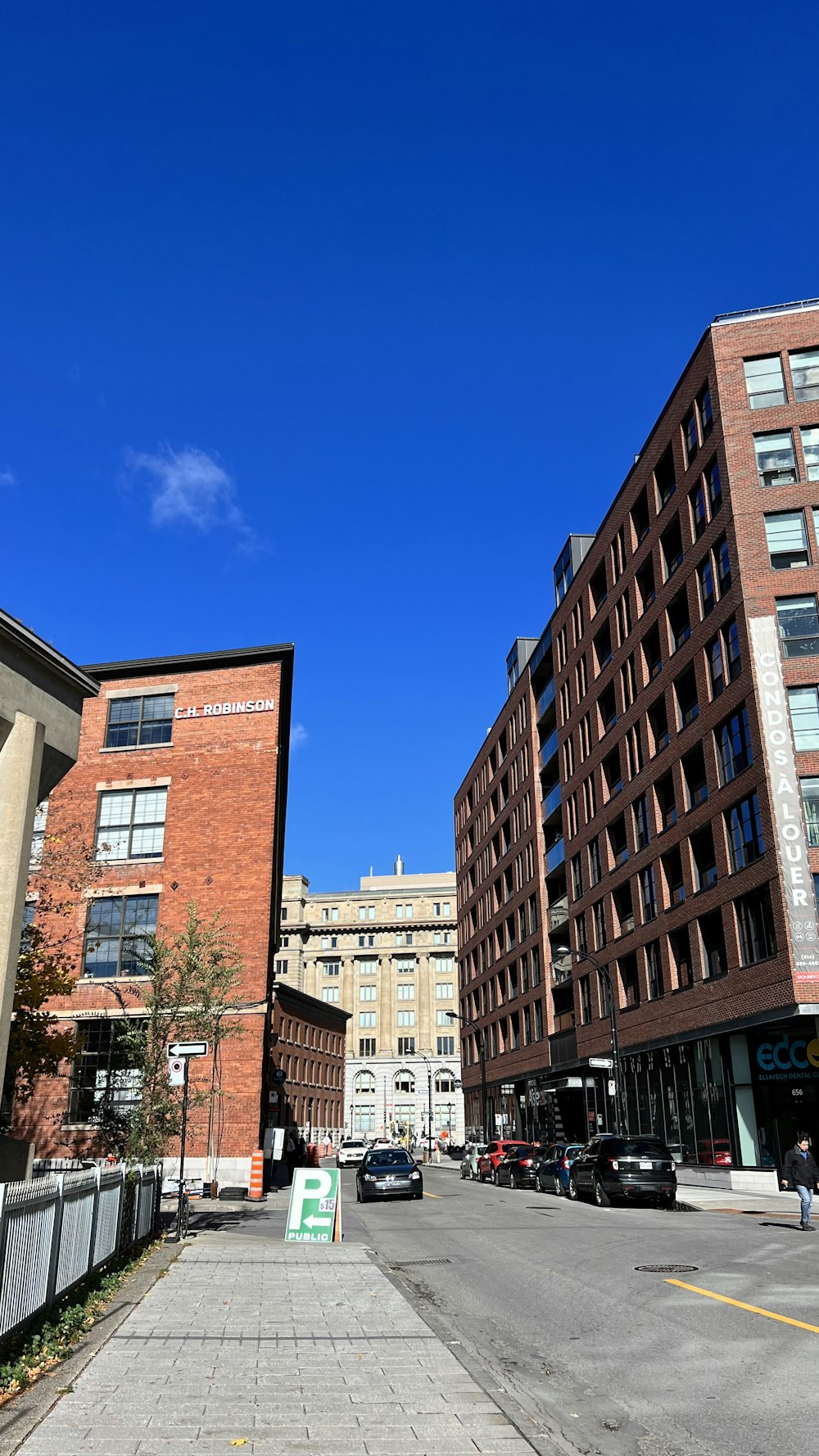 a street with cars and buildings on the side