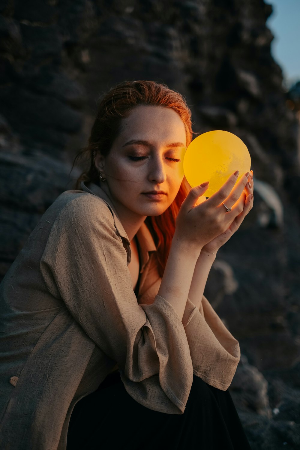 a person holding a yellow balloon