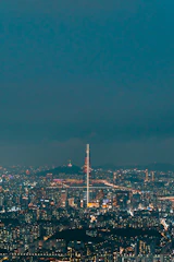 Elegant penthouse with panoramic city skyline views at night.