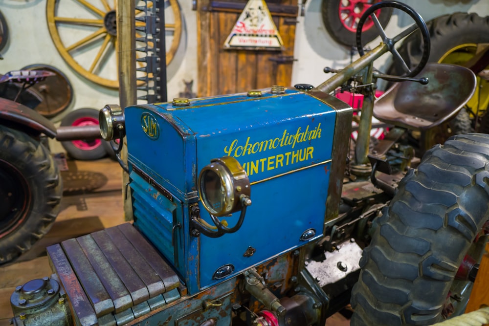 a blue tractor with a yellow sign