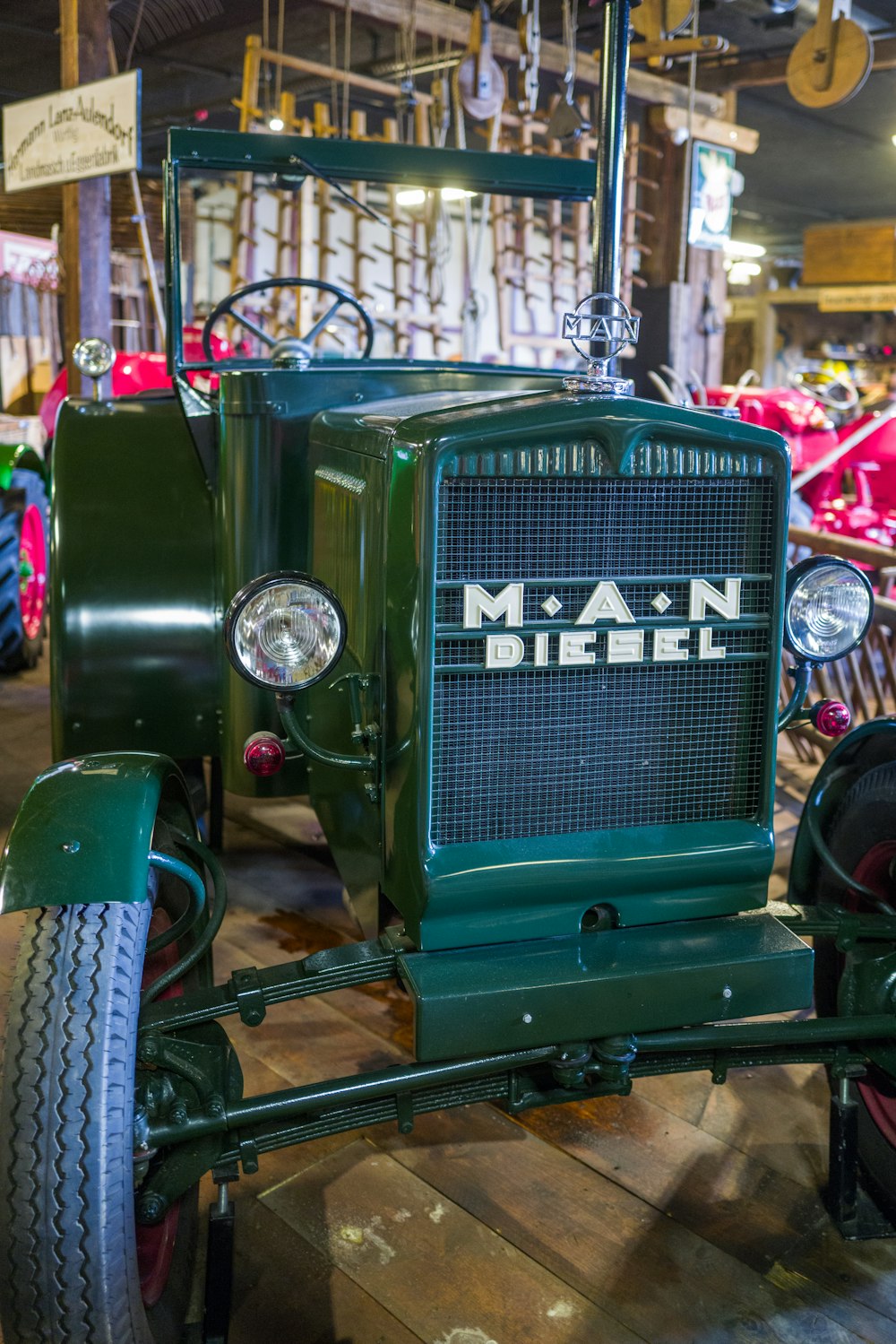 a green tractor in a shop