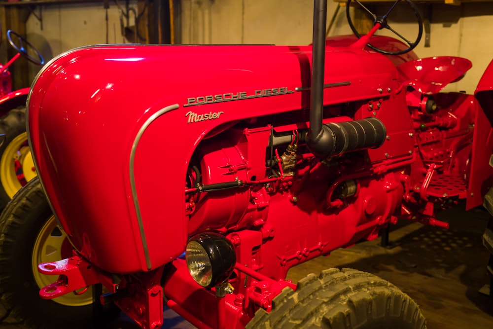 a red tractor in a garage