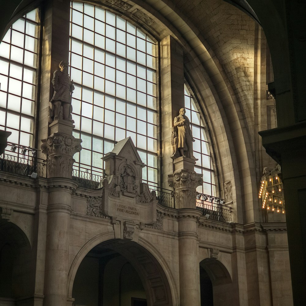 a building with statues and a large window