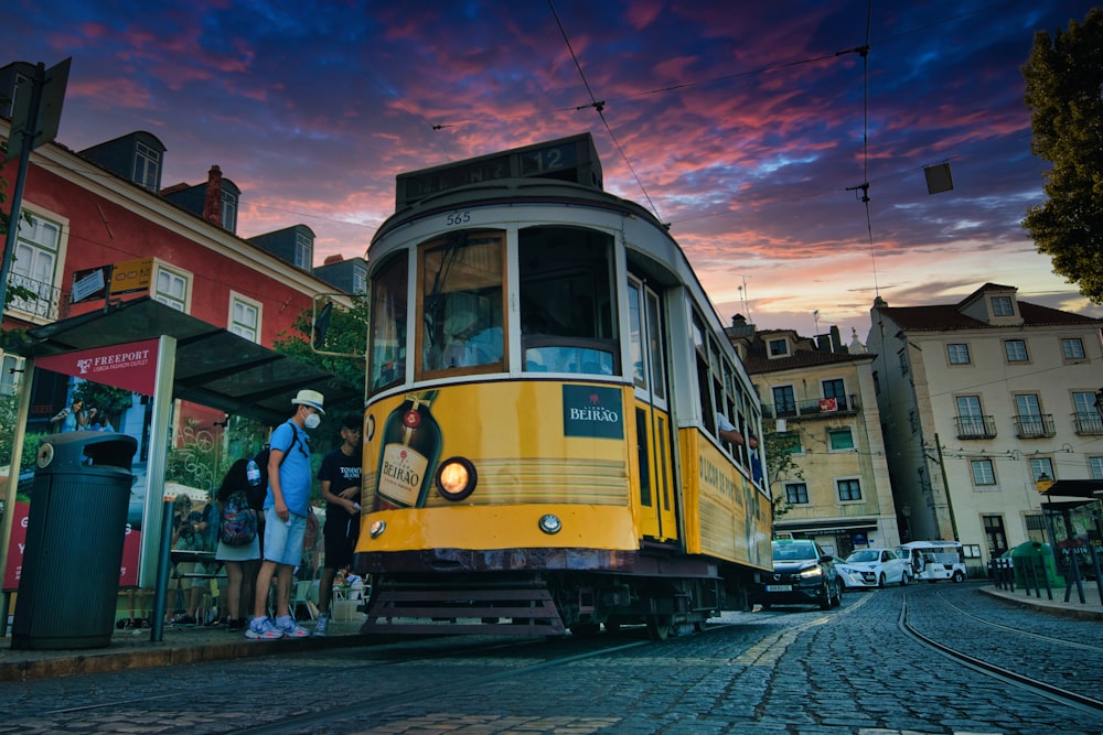 a yellow trolley on a street