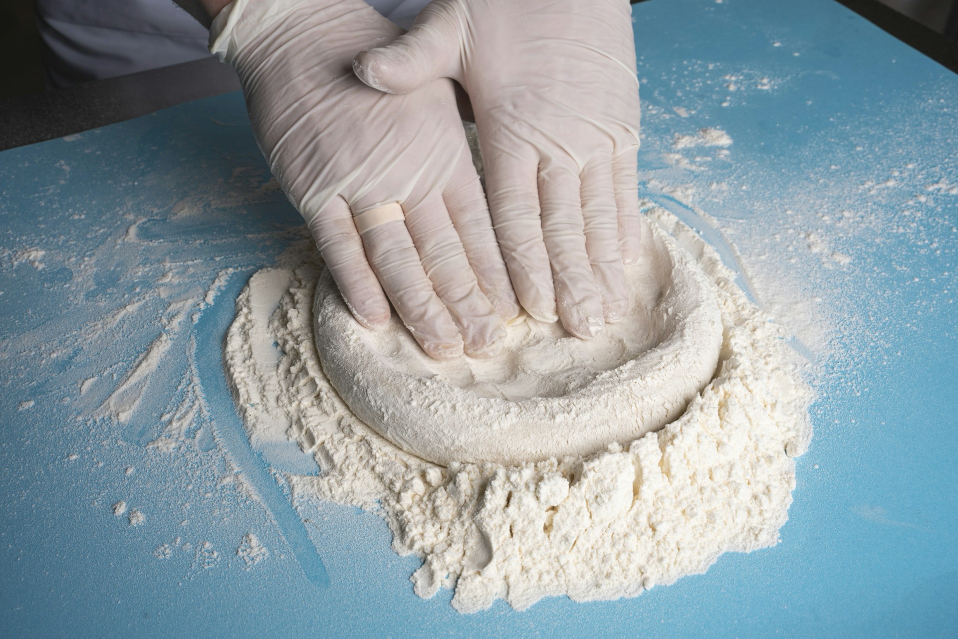 a person's hand holding a white object