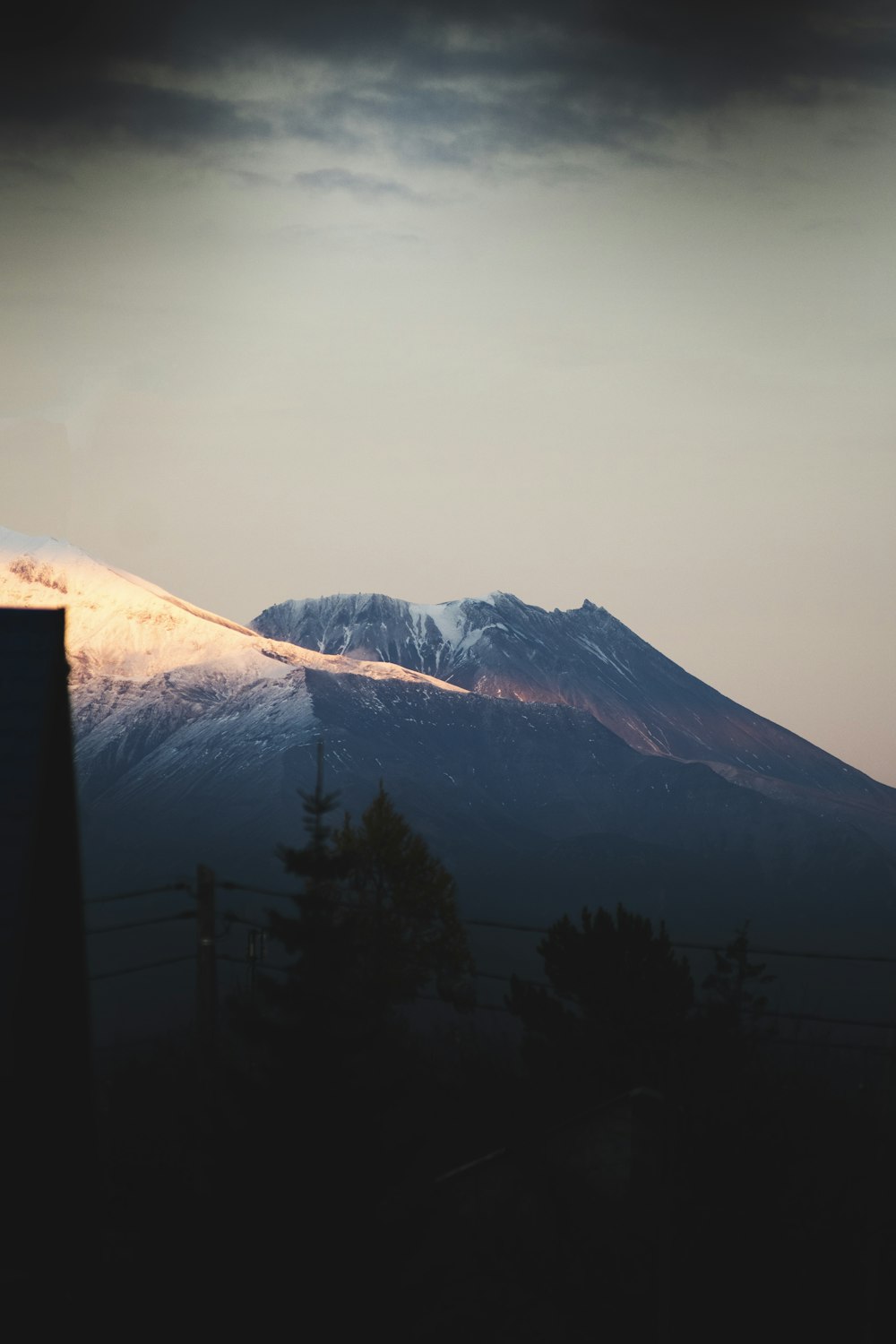 a snowy mountain with trees