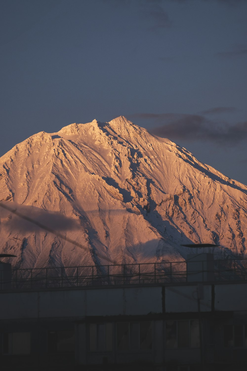 a large mountain with a bridge