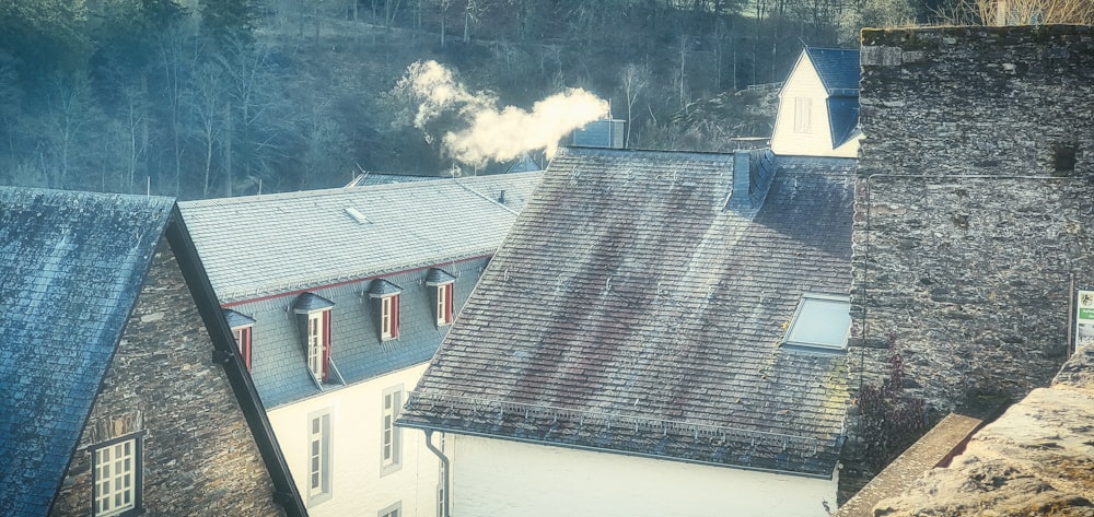 a group of houses with smoke coming out of them