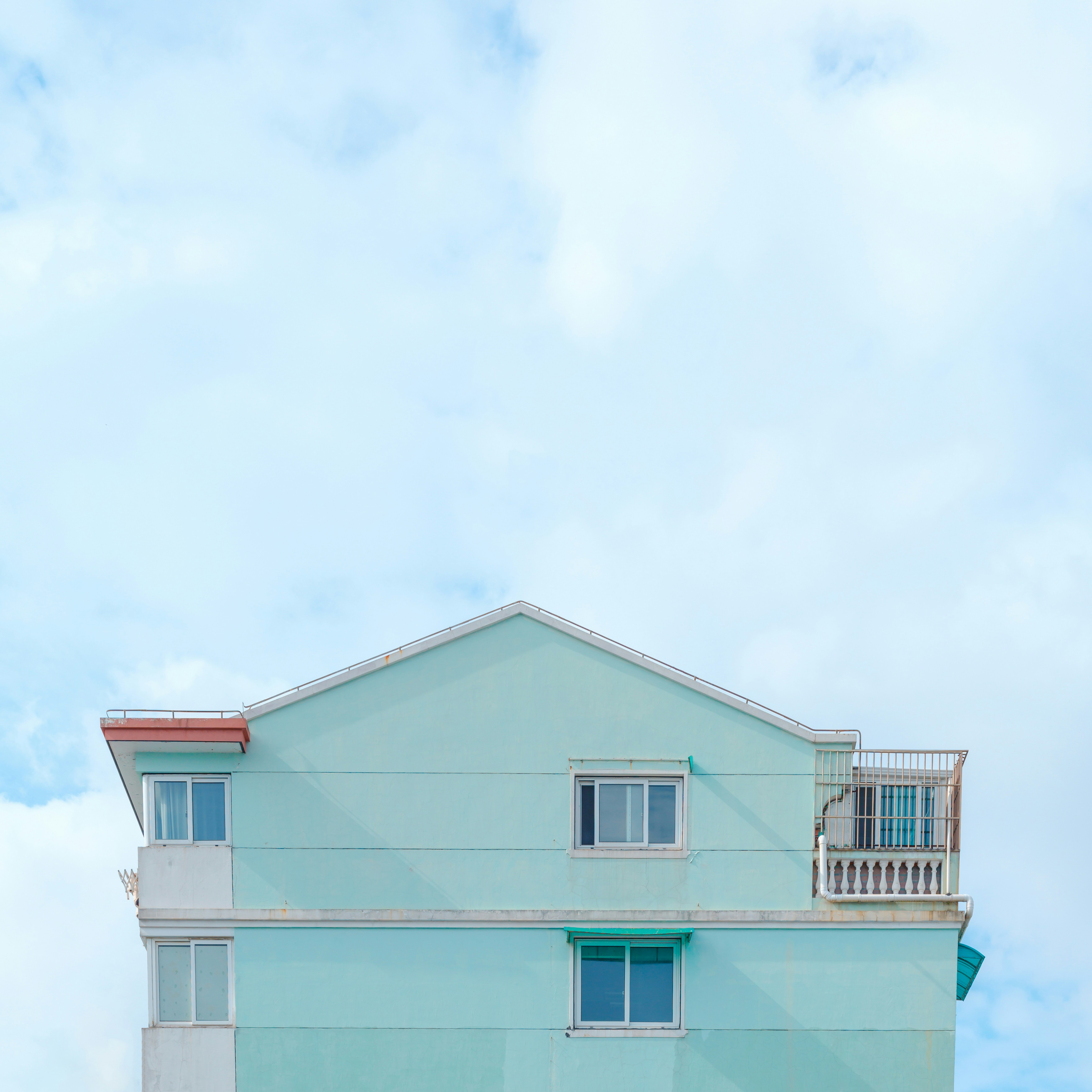 a blue house with a balcony