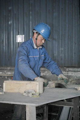 Close-up of safety equipment and blueprints on a worktable.