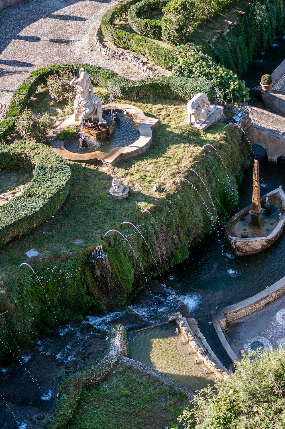 a small pond with a statue in it