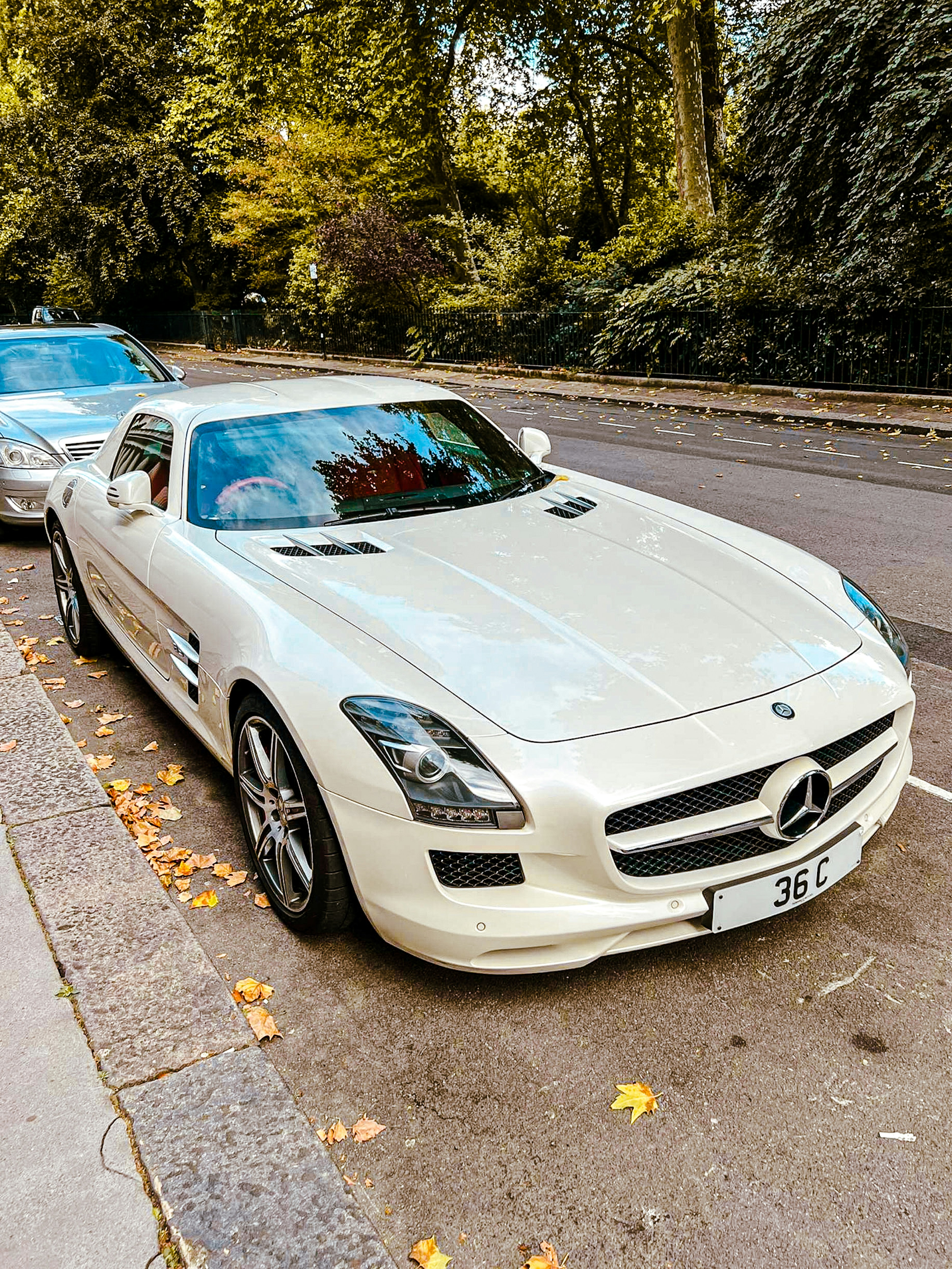 a white car parked on the side of a road
