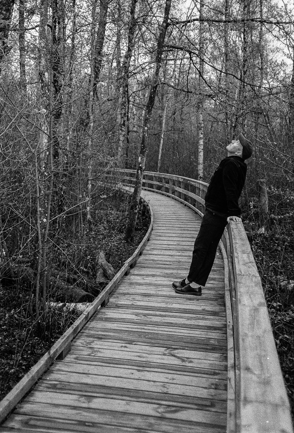 a person walking on a wooden bridge