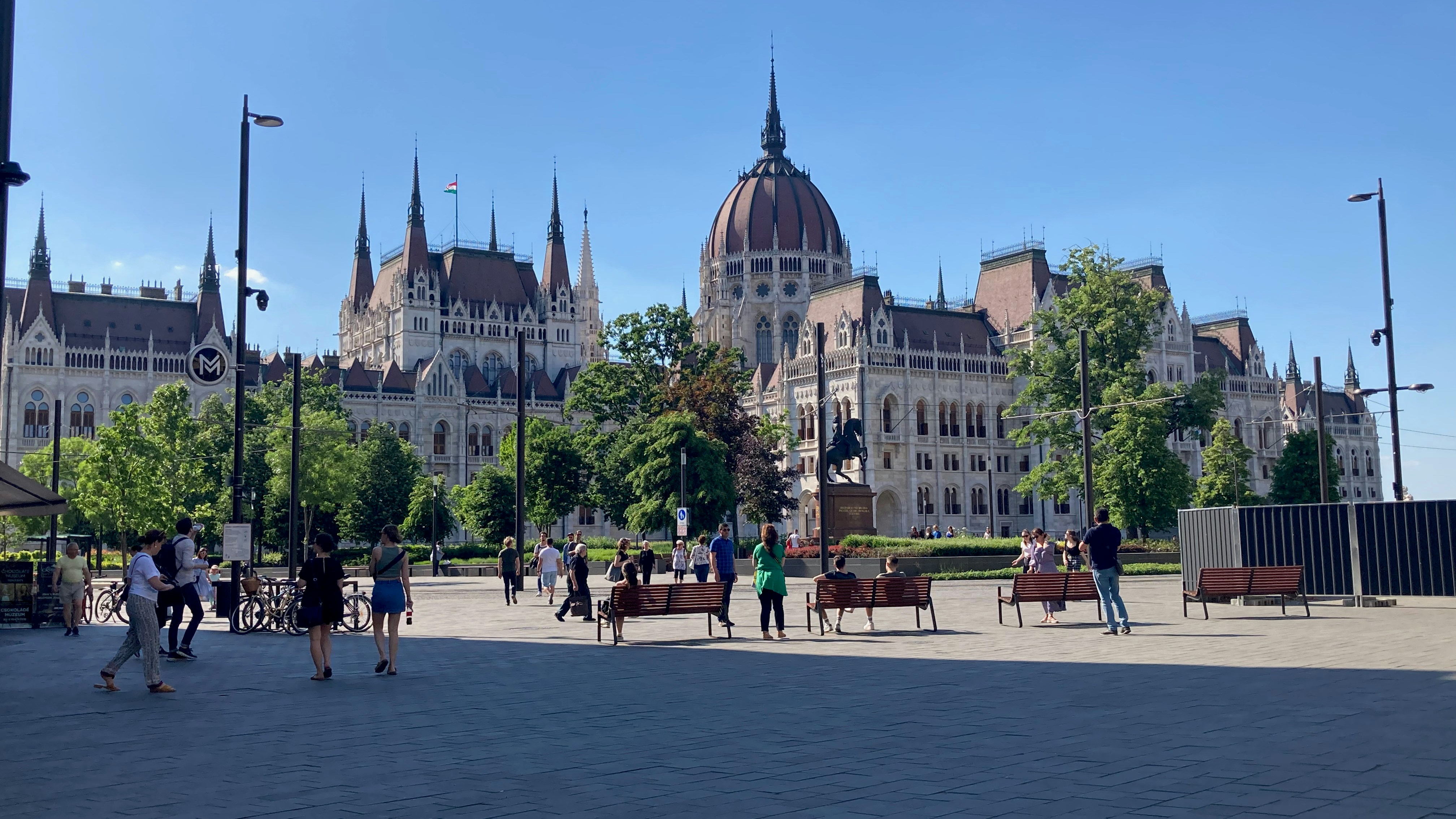 a group of people walking in front of a large building