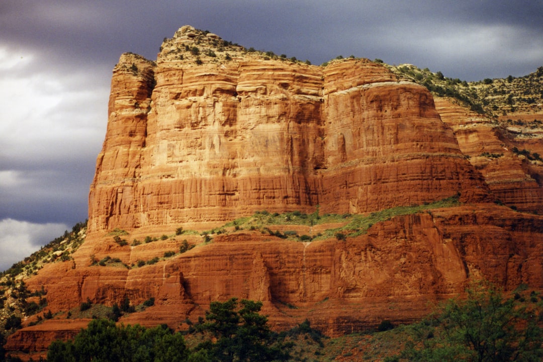 a large rocky cliff with Mehrangarh Fort in the background,