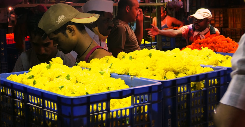 a group of people looking at yellow flowers