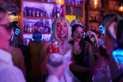 A lively crowd reacting to the walk-in music at a bar.