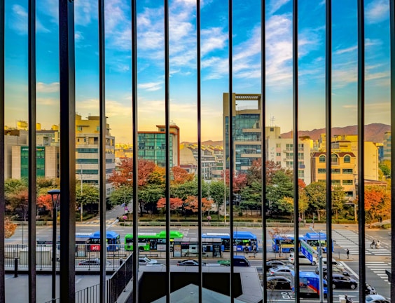 A vibrant vertical video thumbnail showing a city street scene during golden hour.