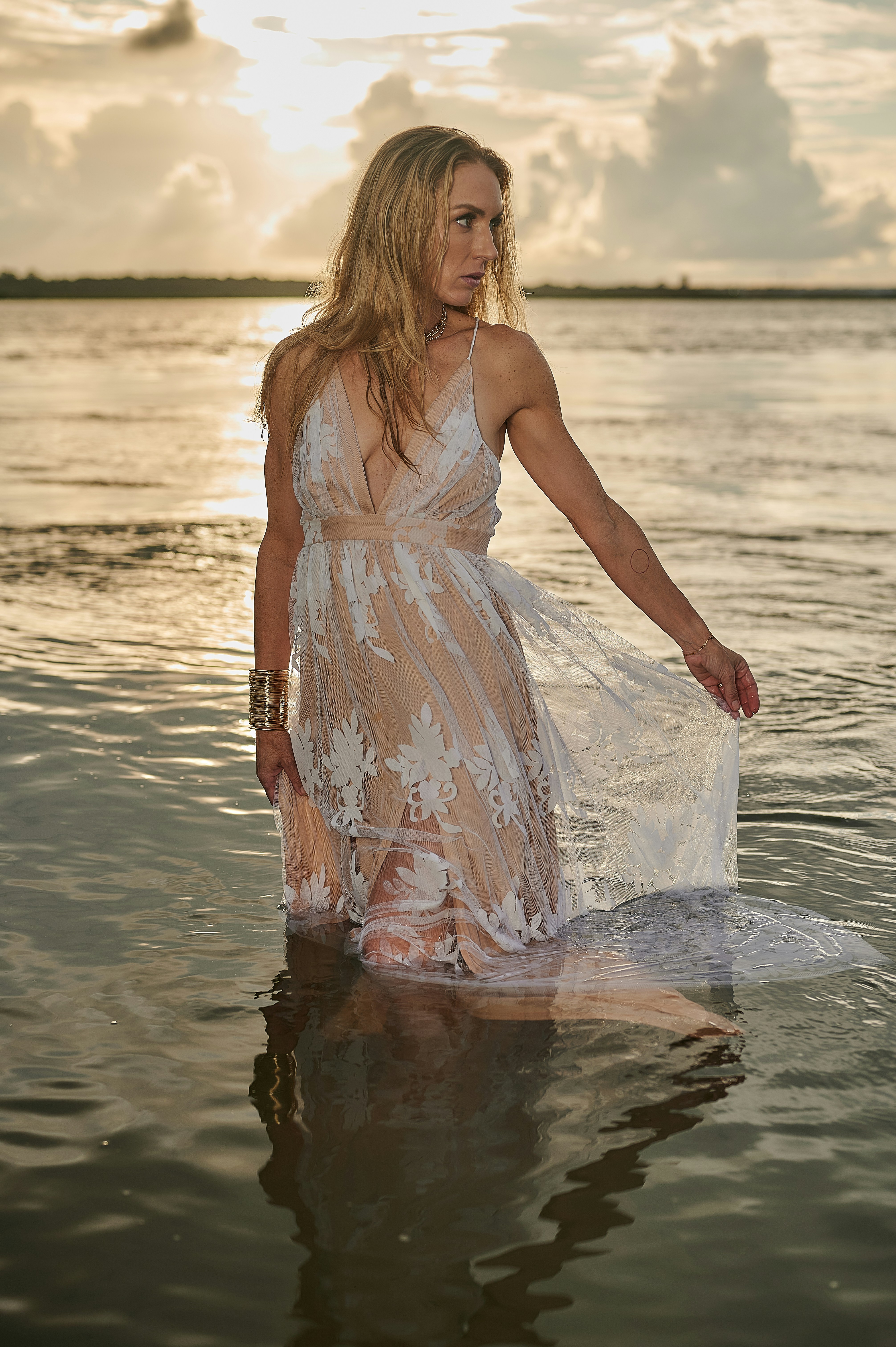 a person in a white dress standing in water