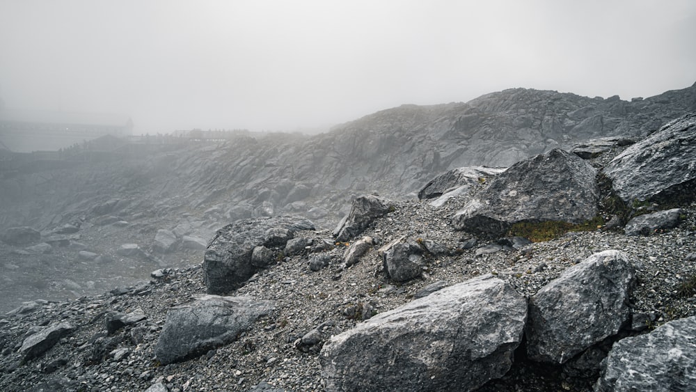 a rocky hillside with fog