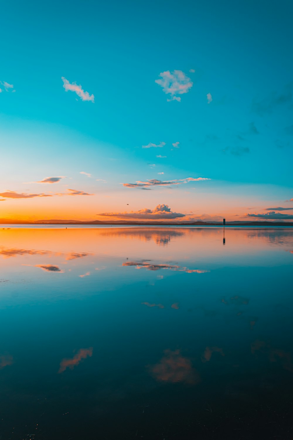 a body of water with a sunset