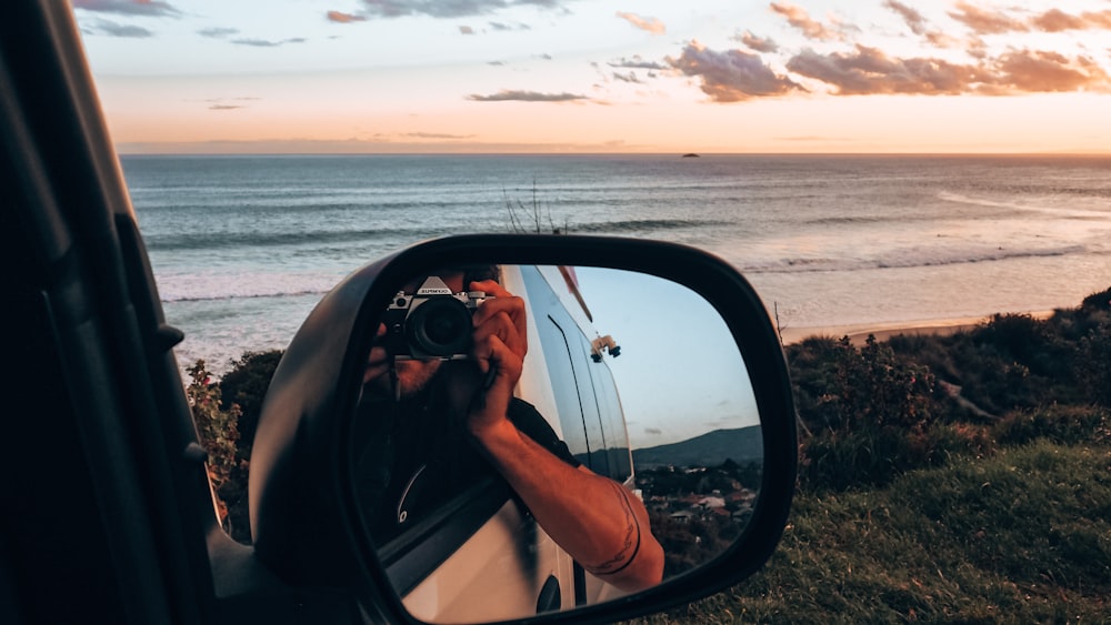 a person taking a picture of the ocean