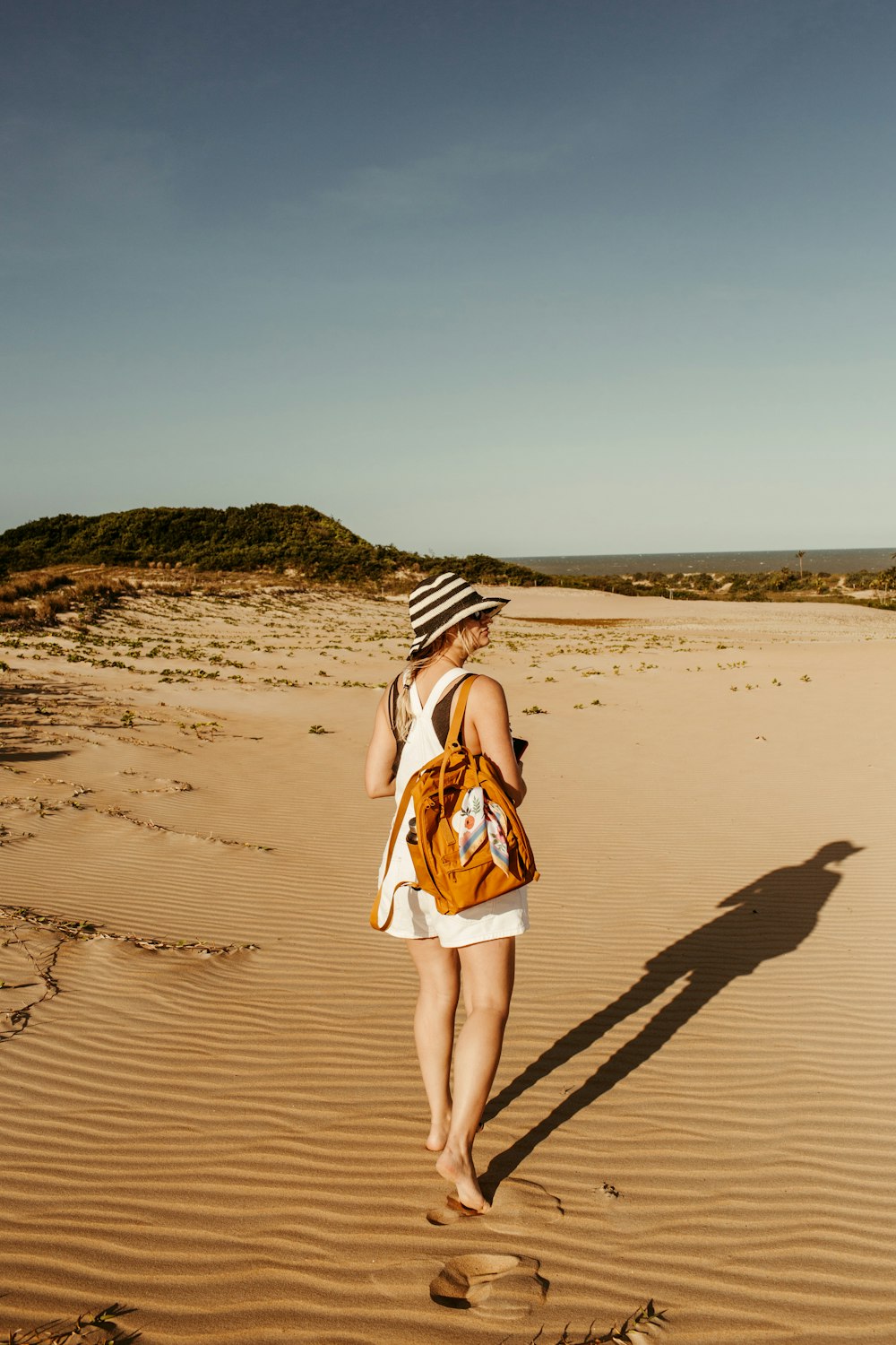 a woman walking on a beach