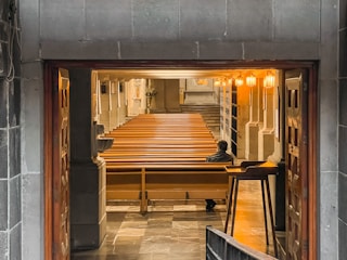 A caring pastor speaking one-on-one with a church member in a quiet room.