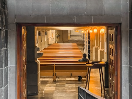 A caring pastor speaking one-on-one with a church member in a quiet room.