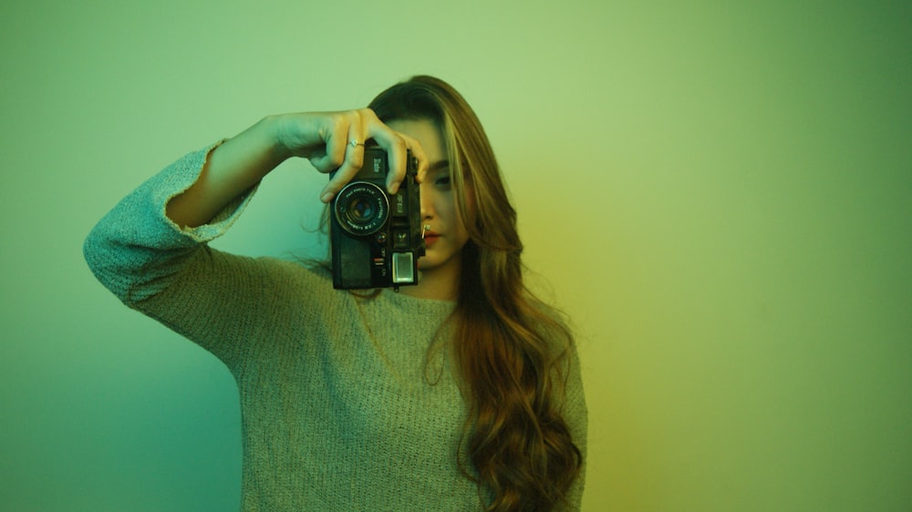 a woman holding a camera