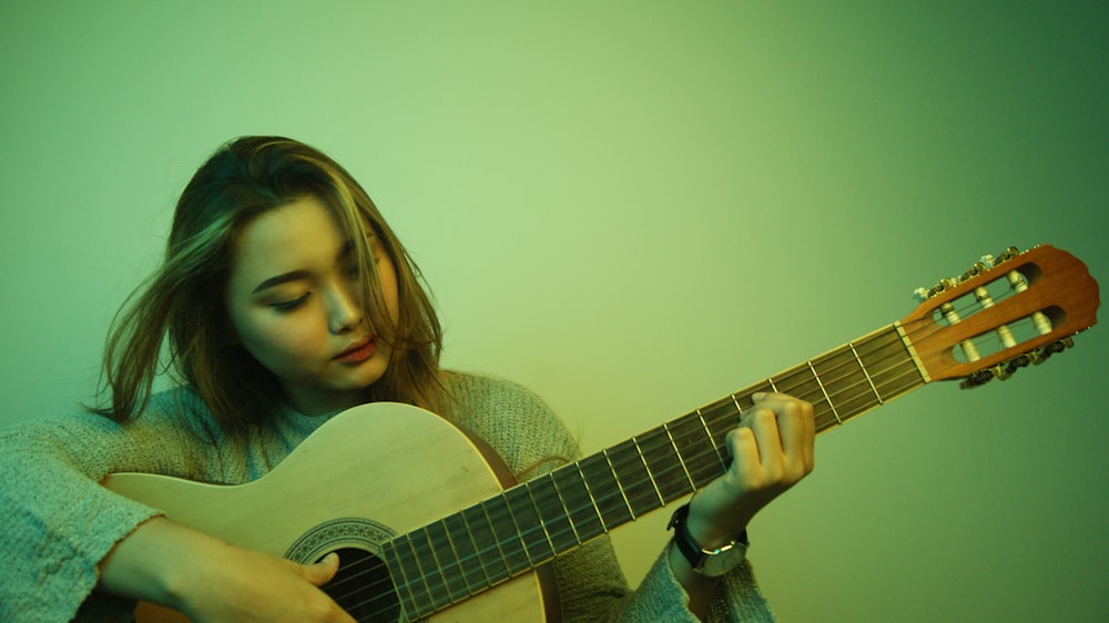a woman playing a guitar