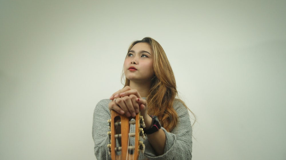 a woman holding a guitar