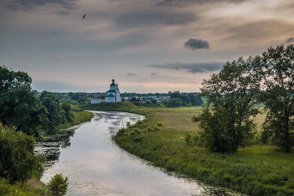 a river with a building in the distance