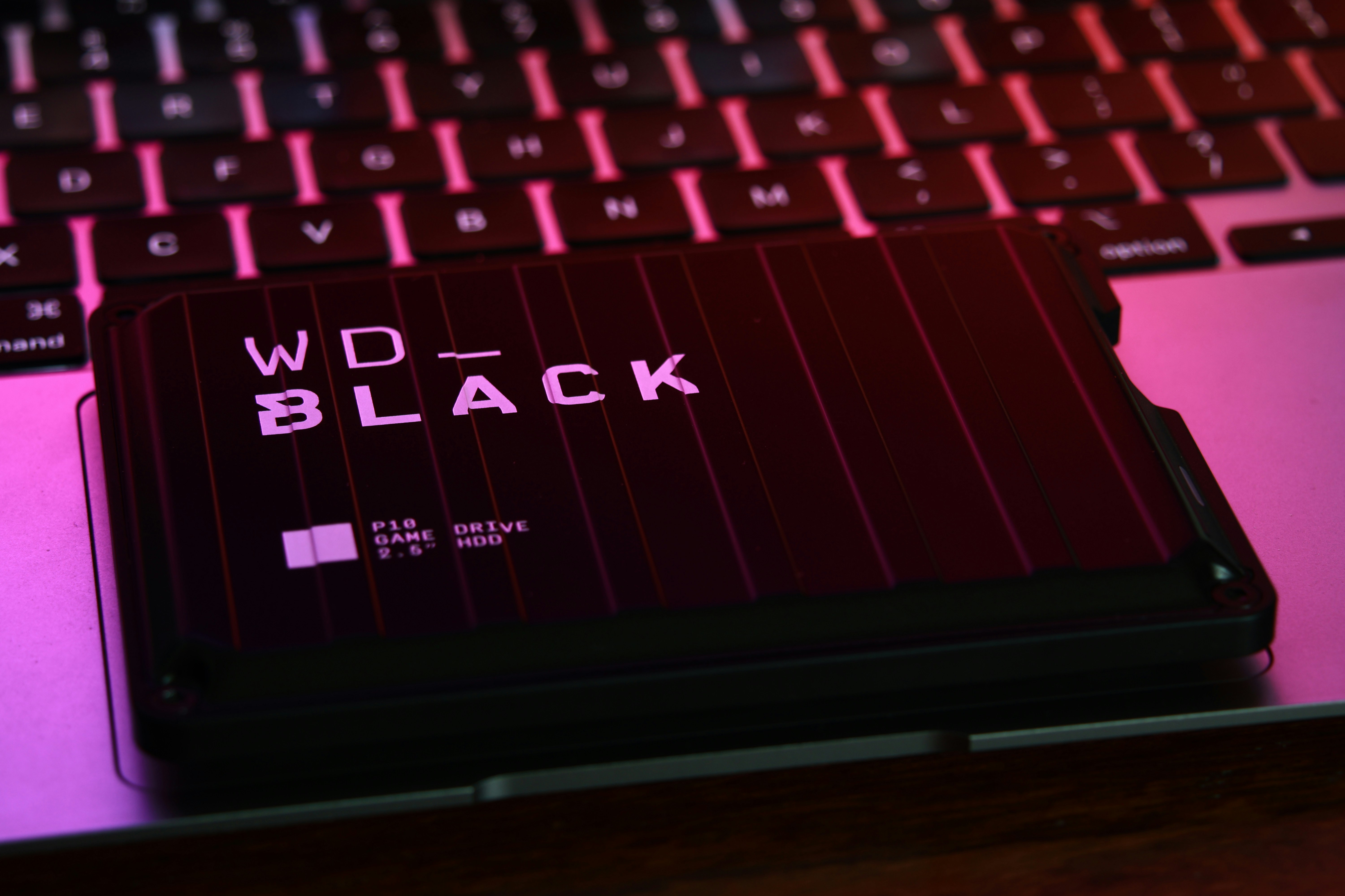 WD Black game drive under a macbook air's glow