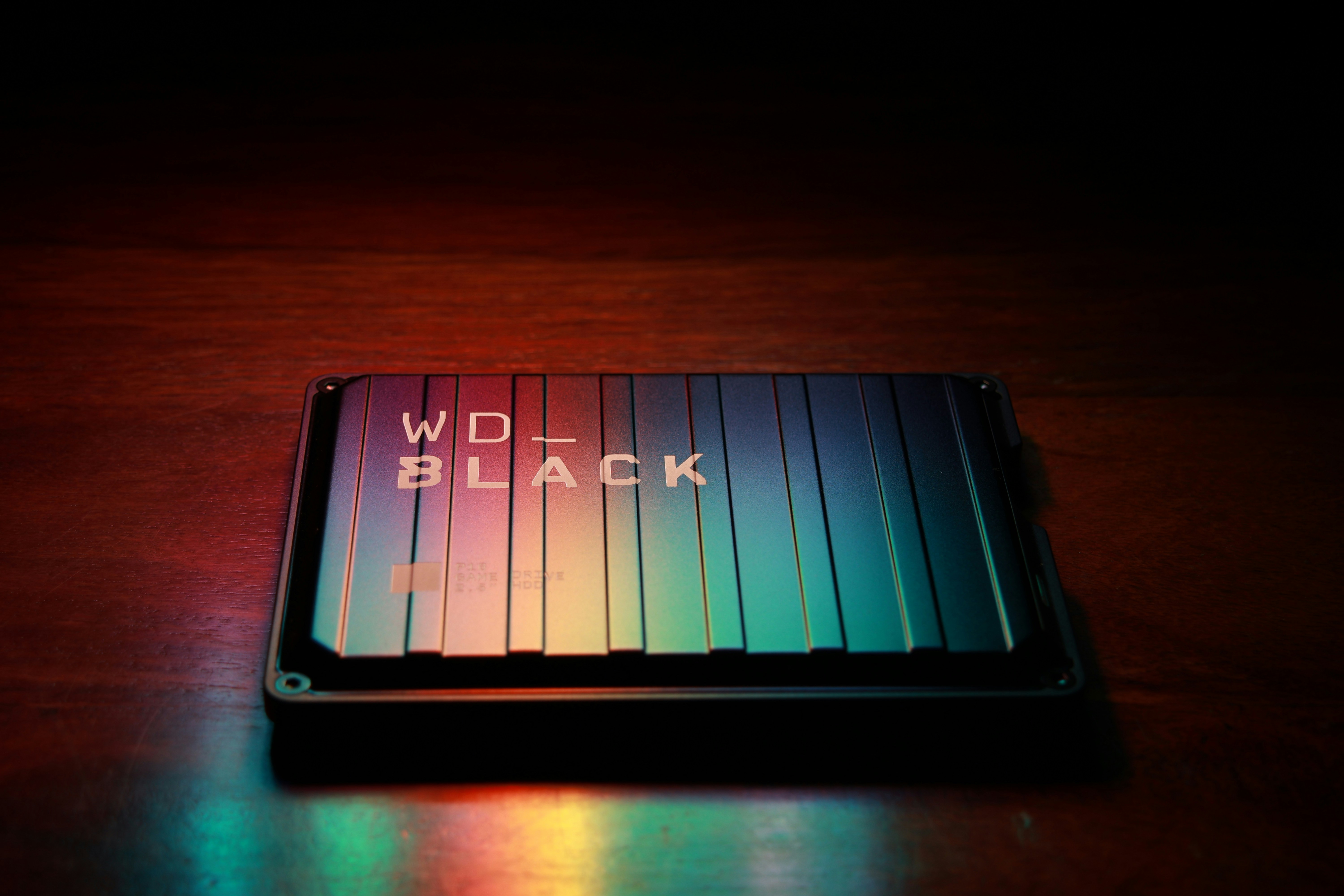 WD Black external USB hard disk in dark glowing with subtle colors