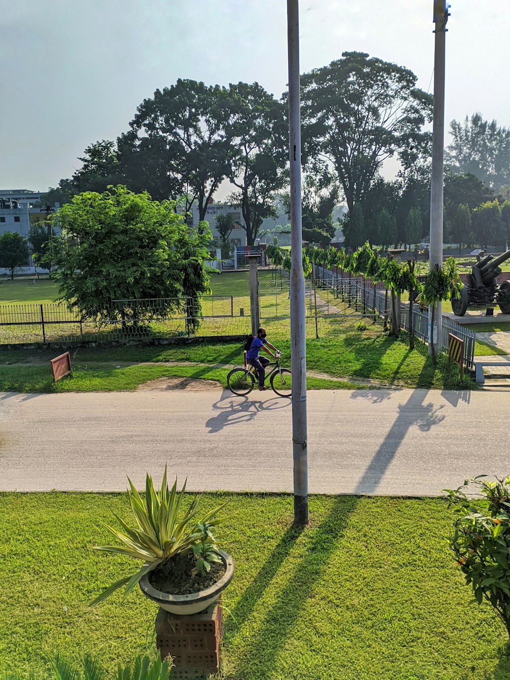a person riding a bike on a path in a park