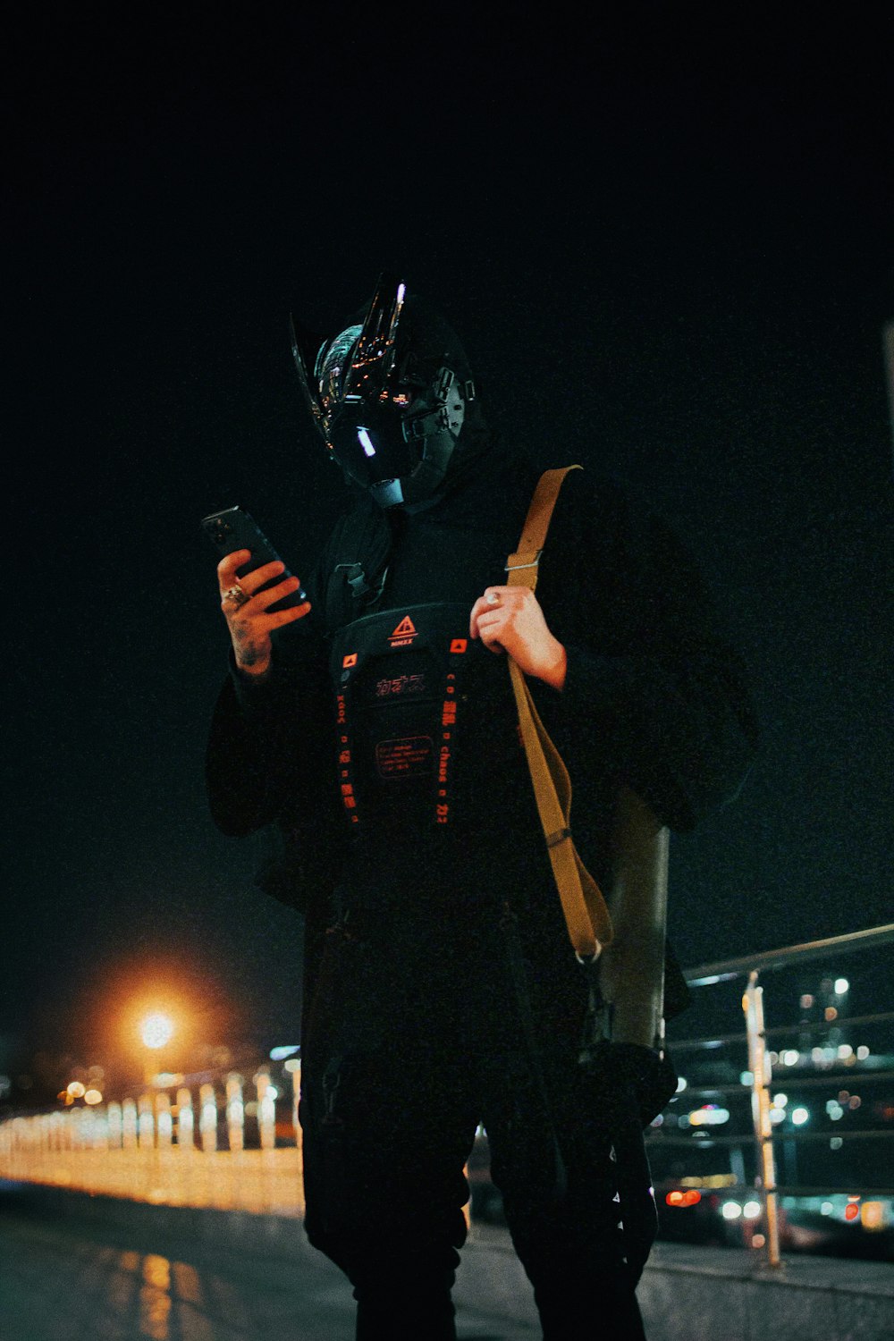 a person wearing a mask and holding a phone