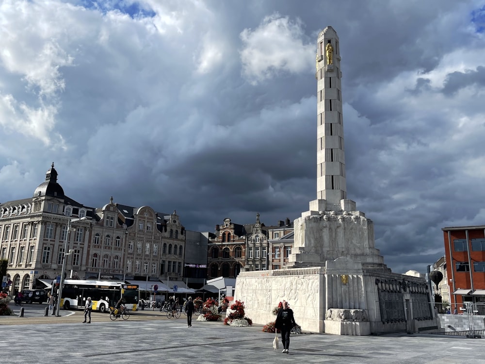 a tall white tower in a city