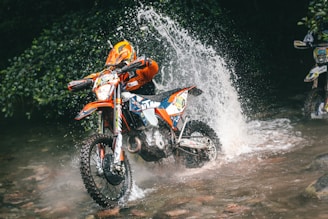a man riding a motorcycle in the mud