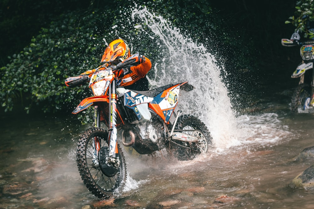 a man riding a motorcycle in the mud