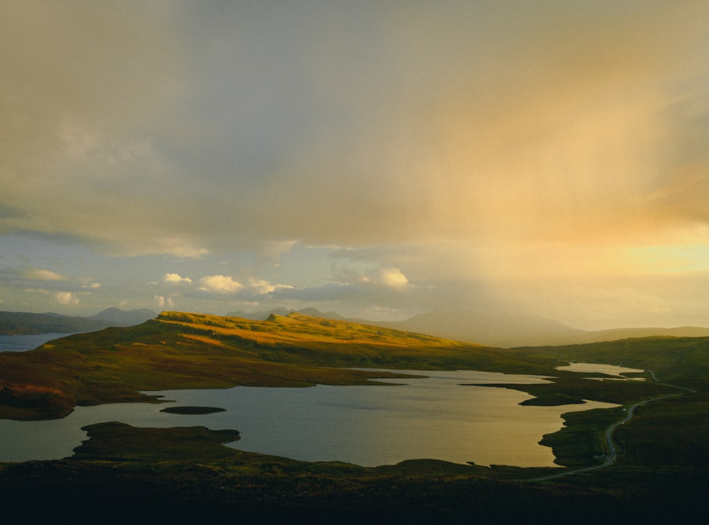 a body of water with hills in the back