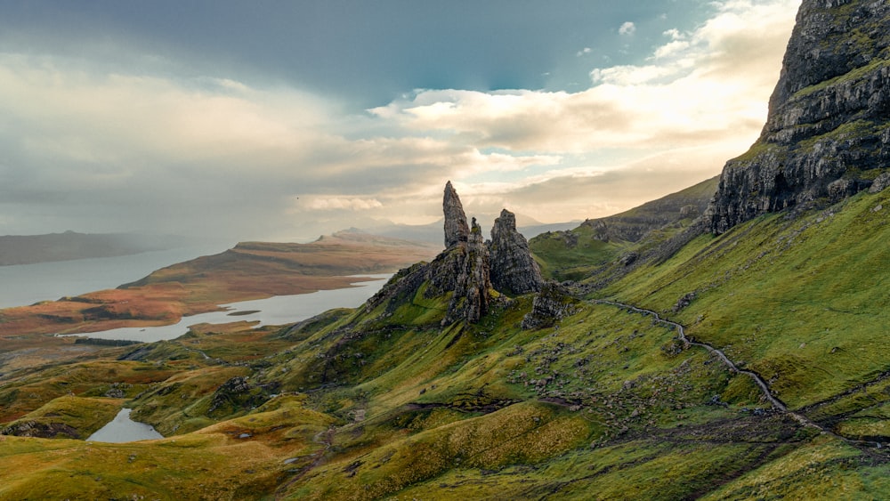 a rocky mountain with a valley below with The Storr in the background