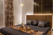 a couch with pillows and a table